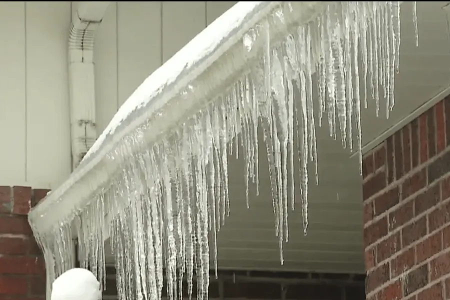 Ice built up along a gutter and roof edge